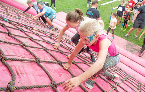 Girls climbing during Pretty Muddy Kids