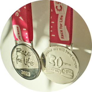 Silver finishers medal with pink ribon